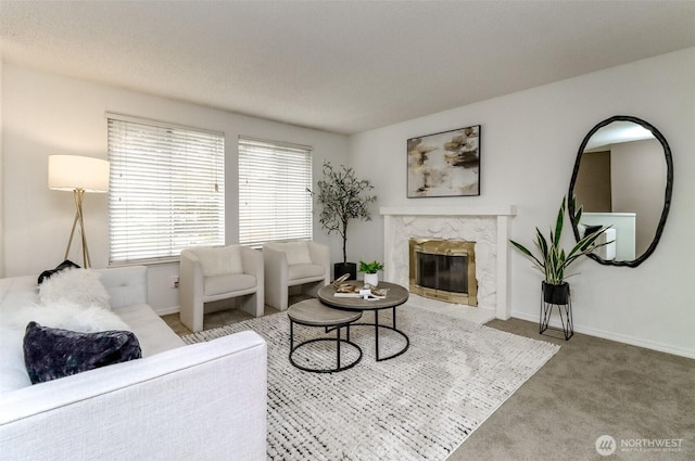 carpeted living room with a fireplace and baseboards