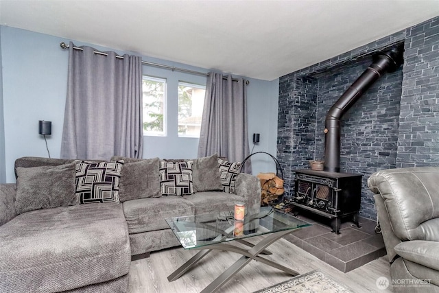 living area featuring a wood stove and wood finished floors