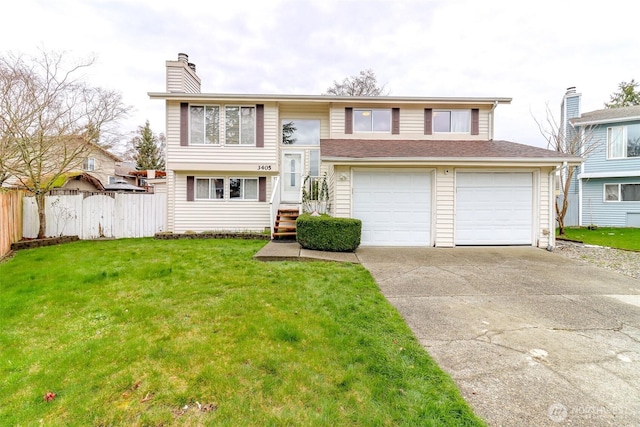 raised ranch with a chimney, concrete driveway, a front yard, and fence