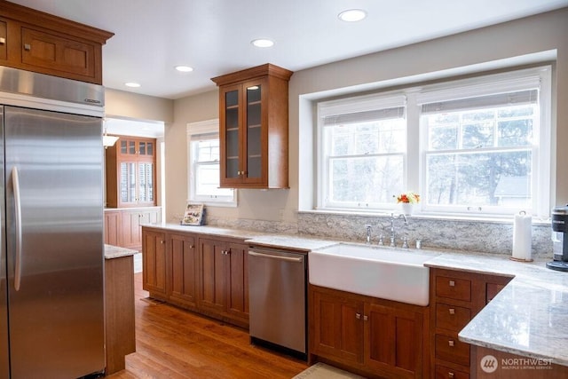 1120 Home Ave, Walla Walla, WA 99362 - kitchen with appliances with stainless steel finishes, a sink, brown cabinetry, glass insert cabinets, and recessed lighting