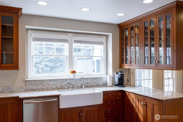 1120 Home Ave, Walla Walla, WA 99362 - kitchen with stainless steel dishwasher, a sink, brown cabinets, glass insert cabinets, and recessed lighting