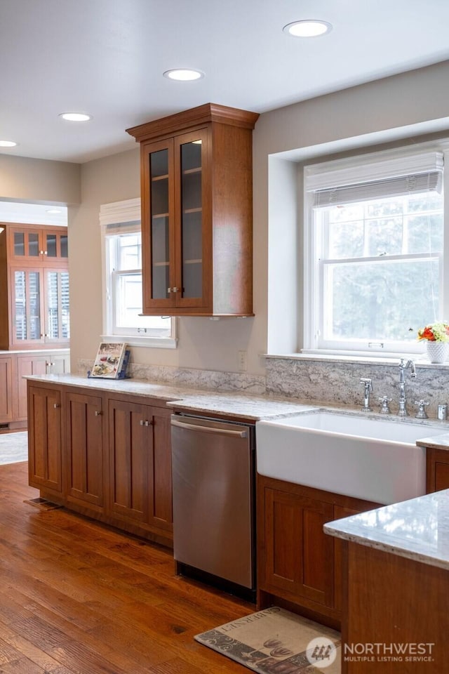 1120 Home Ave, Walla Walla, WA 99362 - kitchen with stainless steel dishwasher, brown cabinets, light stone countertops, glass insert cabinets, and recessed lighting