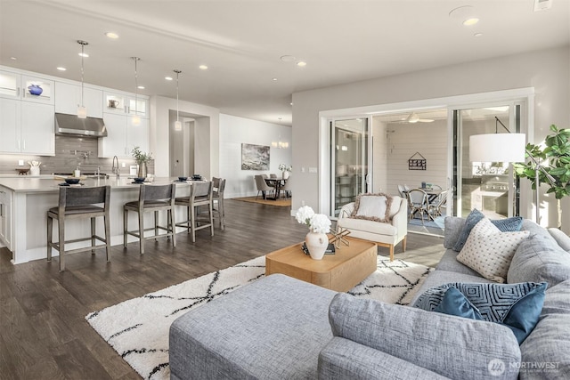 living room featuring recessed lighting and dark wood-style flooring