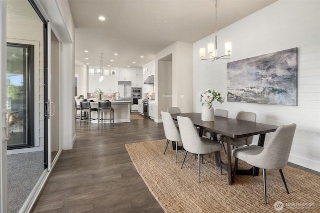 dining area with an inviting chandelier, recessed lighting, and dark wood-style flooring