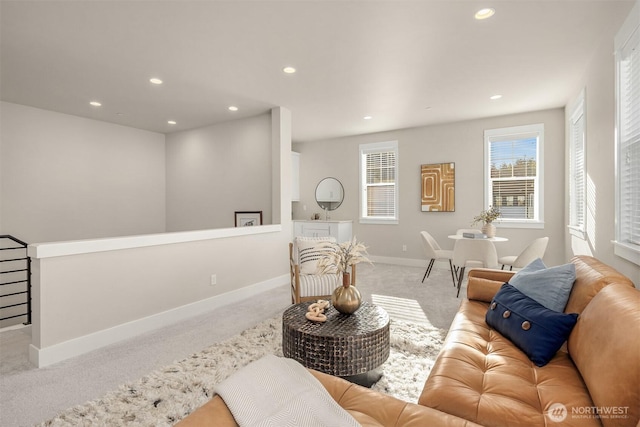 carpeted living area with recessed lighting and baseboards