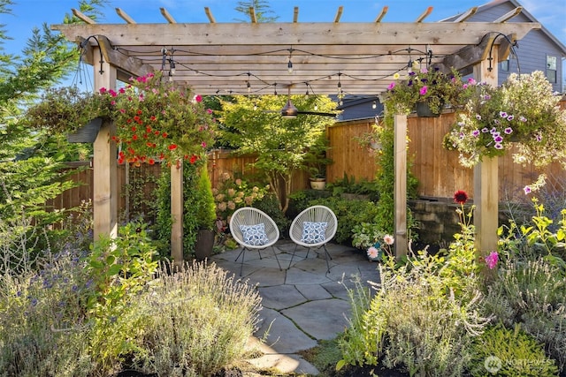 view of patio featuring a pergola and fence