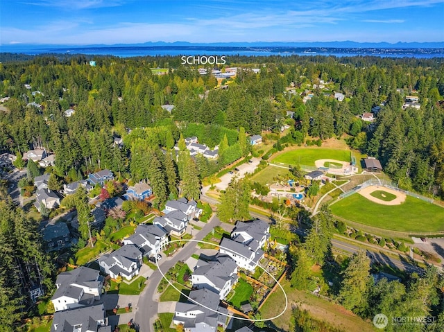 aerial view featuring a mountain view, a forest view, and a residential view