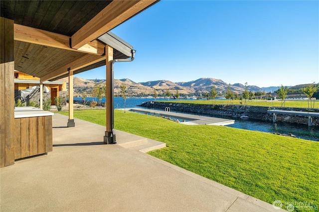 view of yard featuring a patio and a water and mountain view