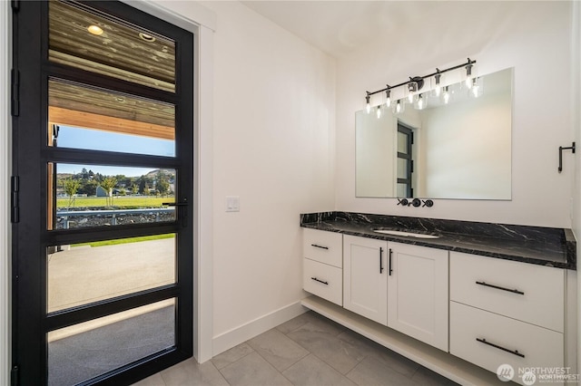 bathroom with vanity, baseboards, and marble finish floor