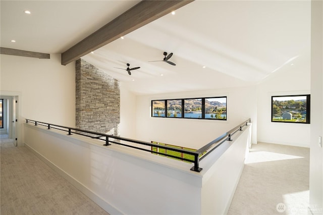 corridor featuring baseboards, an upstairs landing, light colored carpet, and vaulted ceiling with beams