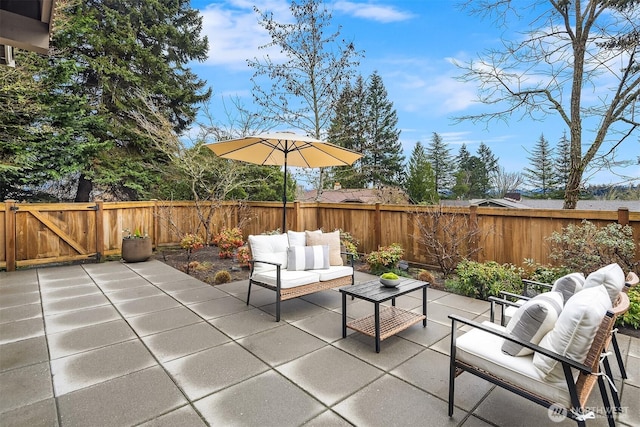 view of patio with an outdoor living space and a fenced backyard