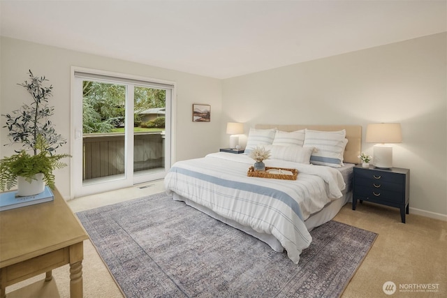 carpeted bedroom featuring visible vents, baseboards, and access to exterior