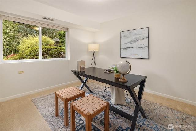 carpeted office featuring visible vents and baseboards