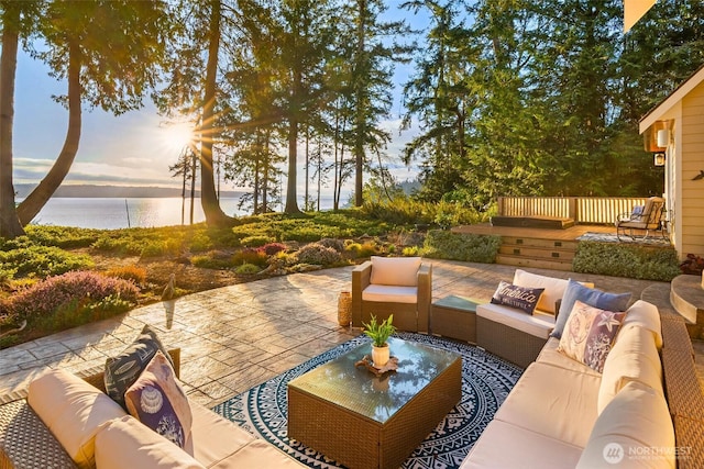 view of patio / terrace with an outdoor living space and a water view