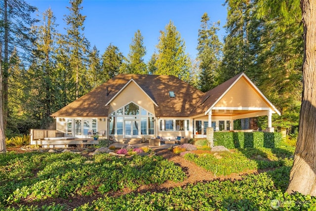 rear view of property featuring a wooden deck