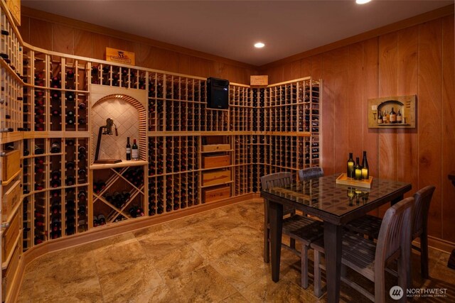 wine cellar with recessed lighting and wood walls