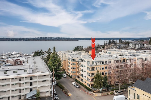 drone / aerial view featuring a view of city and a water view