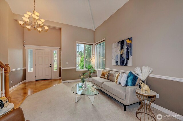 living room with stairway, wood finished floors, and baseboards