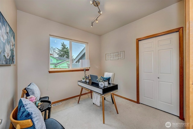 office featuring rail lighting, carpet flooring, baseboards, and visible vents