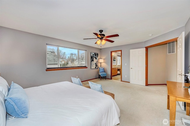 bedroom featuring a ceiling fan, baseboards, visible vents, ensuite bathroom, and light carpet