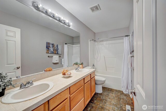 full bathroom featuring visible vents, shower / tub combo with curtain, and a sink