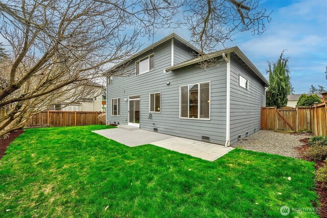 rear view of property featuring a lawn, a fenced backyard, crawl space, a patio, and a gate