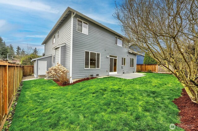 rear view of property with a yard, a fenced backyard, and a patio area