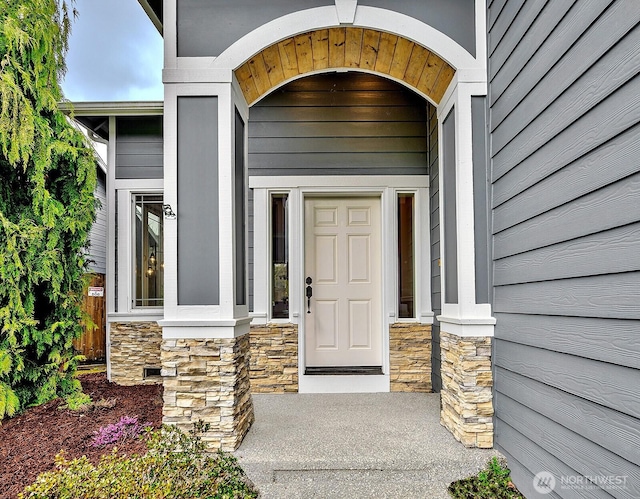 property entrance featuring stone siding