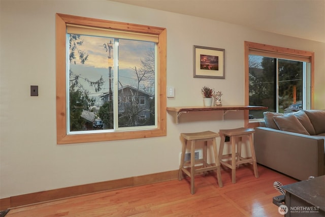 dining space featuring visible vents, baseboards, and wood finished floors