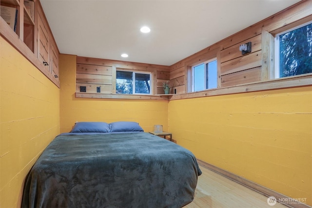 bedroom with recessed lighting and wood finished floors