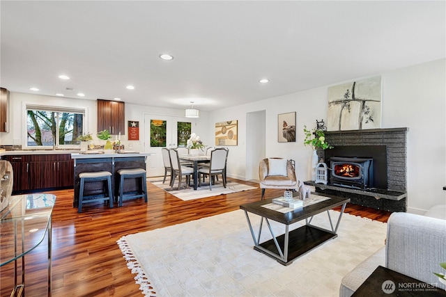 living room featuring recessed lighting, light wood-style floors, and a wealth of natural light