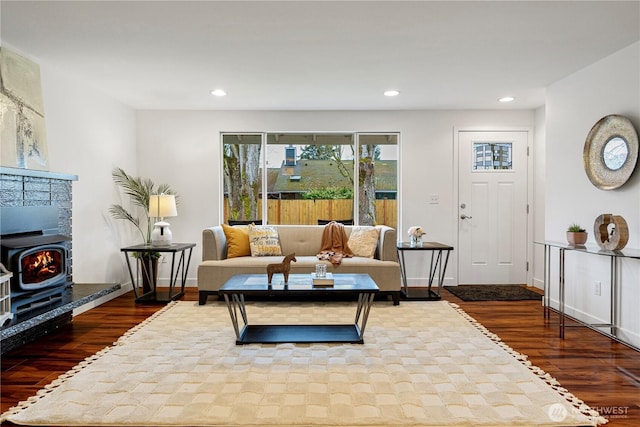 living room with recessed lighting, baseboards, and dark wood-style flooring