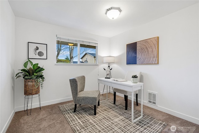 carpeted office space featuring visible vents and baseboards