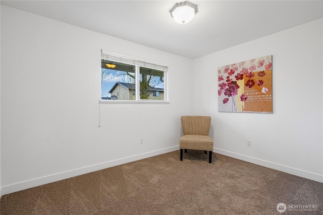 living area featuring carpet flooring and baseboards