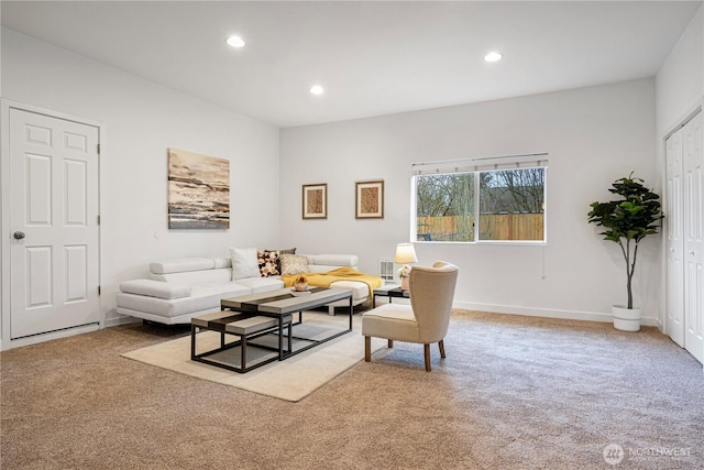 carpeted living area featuring recessed lighting and baseboards