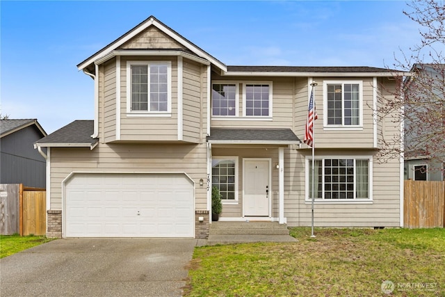 view of front facade featuring a front lawn, an attached garage, fence, and driveway