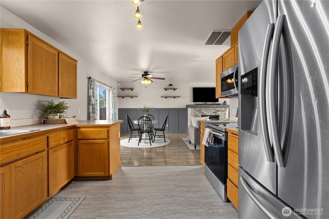 kitchen featuring visible vents, appliances with stainless steel finishes, a ceiling fan, and light countertops