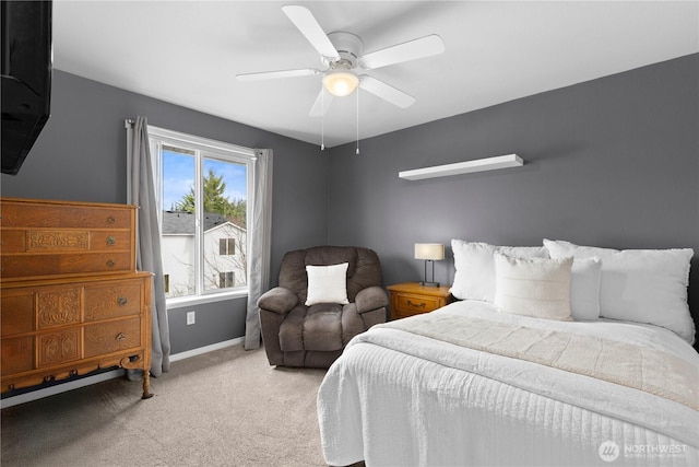 bedroom with light colored carpet, baseboards, and ceiling fan