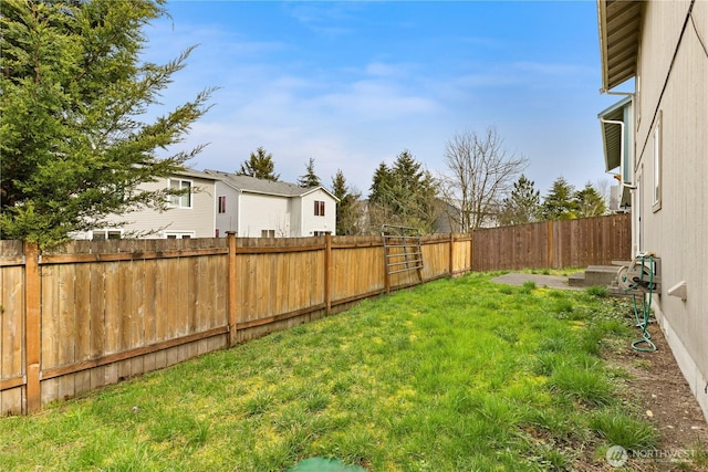 view of yard with a fenced backyard