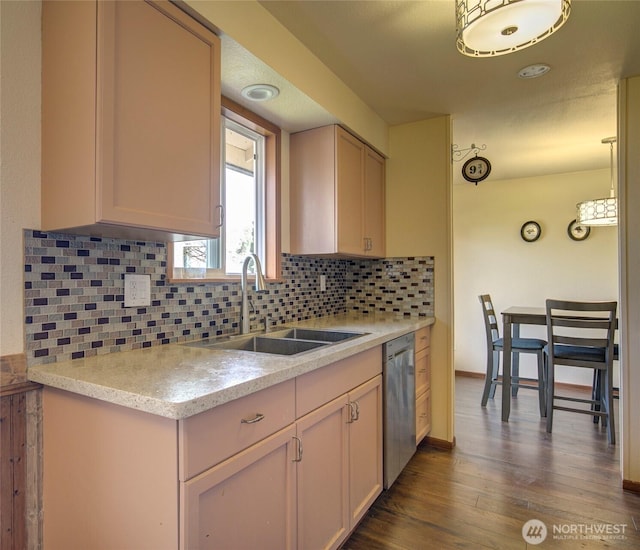 kitchen featuring a sink, stainless steel dishwasher, dark wood-style floors, decorative backsplash, and baseboards