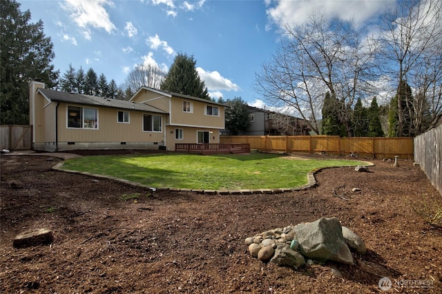 back of property featuring a deck, a yard, a fenced backyard, and crawl space