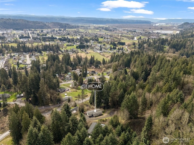 birds eye view of property with a view of trees