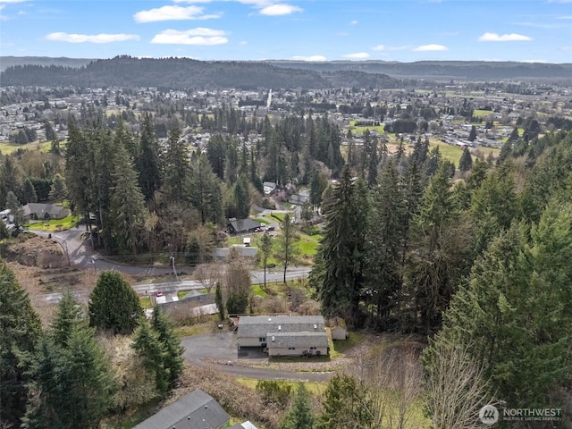 birds eye view of property with a wooded view