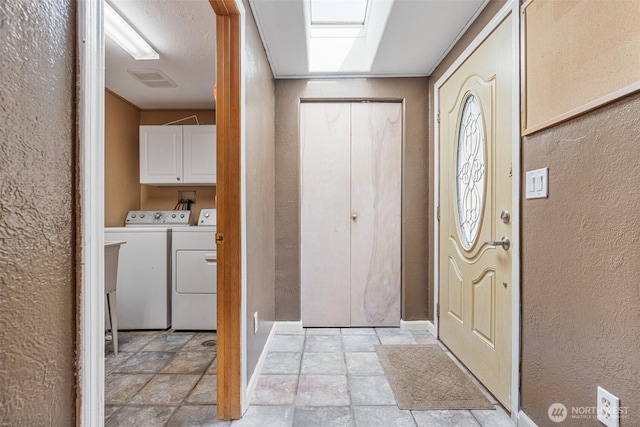 entrance foyer with washing machine and dryer and a textured wall