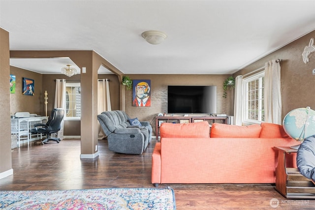 living area with baseboards and wood finished floors