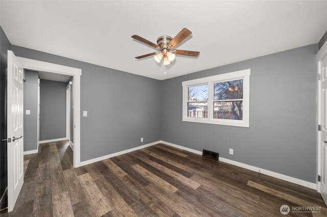 unfurnished bedroom with visible vents, dark wood-style floors, baseboards, and ceiling fan