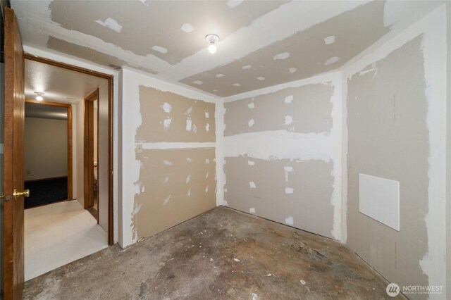 spare room featuring unfinished concrete flooring