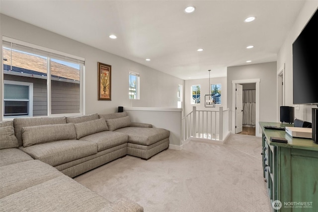 living room with recessed lighting, baseboards, plenty of natural light, and light colored carpet