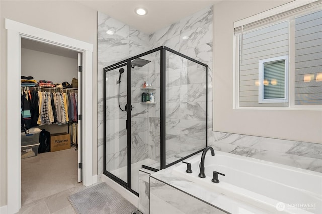 full bathroom with a marble finish shower, recessed lighting, a spacious closet, and a bath