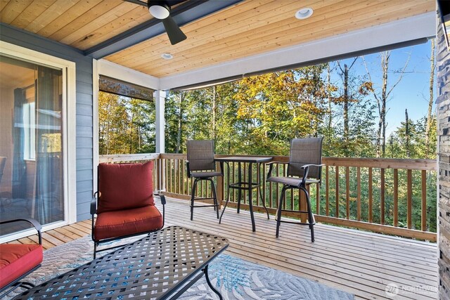 sunroom with wood ceiling and ceiling fan